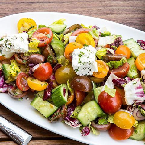 Greek salad with feta cheese, olives and tomatoes.