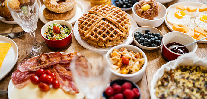 Family-style brunch with eggs, breads, preserves, salads